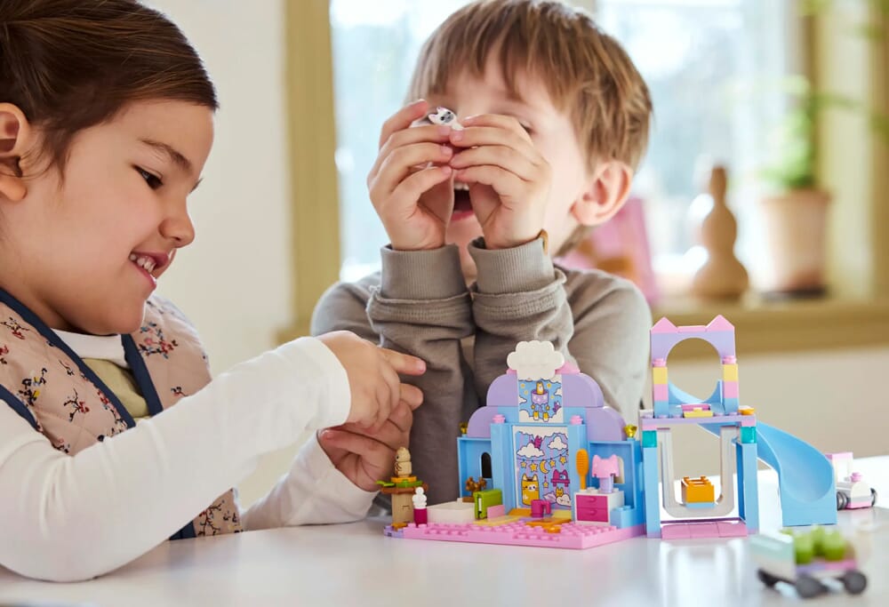 Dzieci bawiące się zestawem LEGO Friends Gabby's Dollhouse Kitty Care